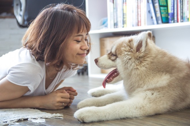girl and dog smiling at each other